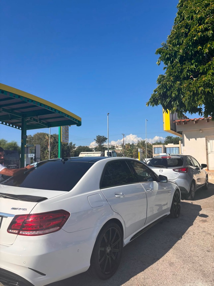 White Mercedes-AMG being dried at the StarOil pumps in Chlorakas