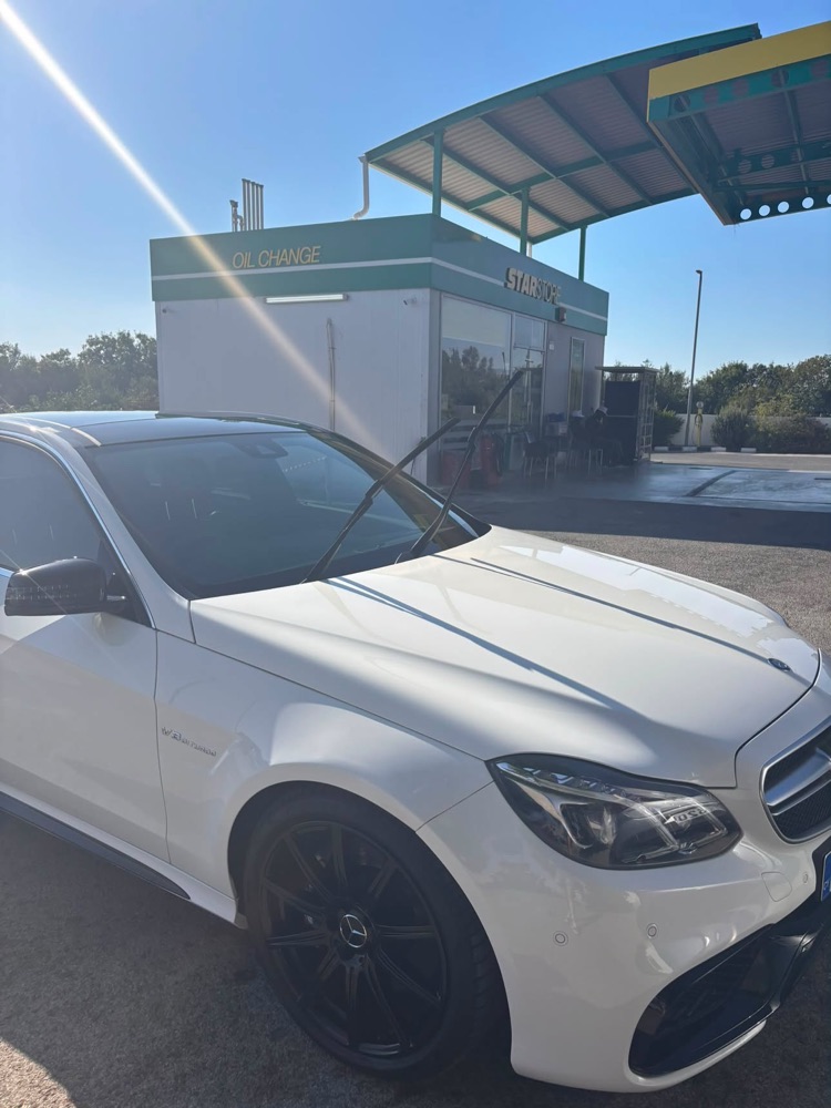 Close-up of a freshly finished white Mercedes-AMG at GlossLab, StarStore in the background